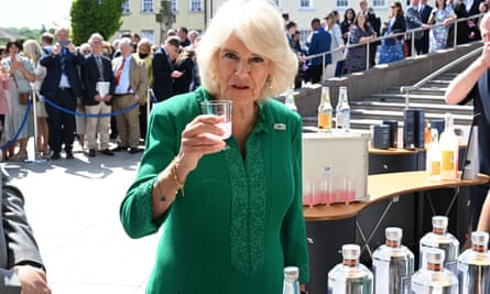 Queen Camilla with a plastic cup of drink in Market Theatre Square, Armagh, Northern Ireland