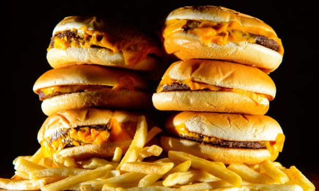 Pile of cheeseburgers and chips