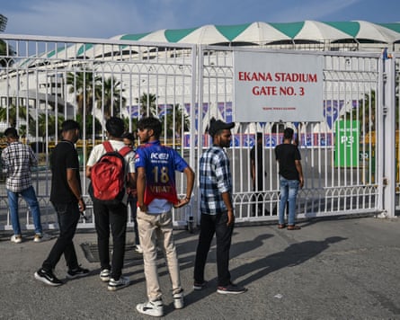 Cricket fans stand outside the Ekana Cricket Stadium in Lucknow on 9 May
