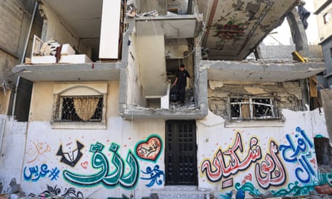 Palestinians asses the damage after an Israeli strike in the Nuseirat refugee camp, central Gaza, on Saturday