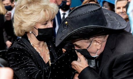 Molly Meldrum comforts Patti Newton at the state funeral for entertainment legend Bert Newton in Melbourne.