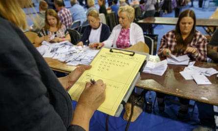 Staff count ballot papers at the Emirates Arena in Glasgow, Scotland, after polls closed in the EU referendum.