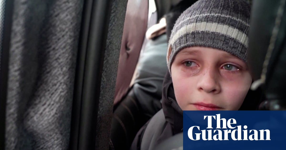‘We left our Dad in Kyiv’: young Ukrainian boy in tears after fleeing capital – video