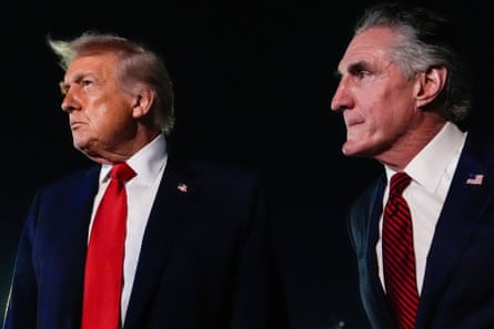 two men in suits look off to the side