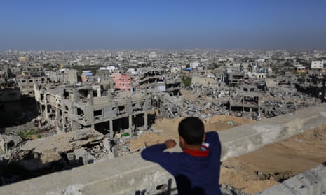 A Palestinian youth looks at rubble of houses which were damaged during the 50-day Gaza war between Israel and Hamas-led militants
