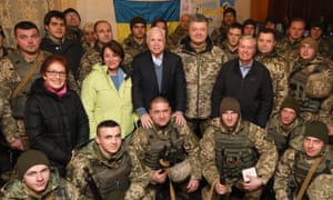 US ambassador to Ukraine Marie Yovanovitch, US senators Amy Klobuchar, John McCain, Ukraine’s president Petro Poroshenko and US senator Lindsey Graham (left to right at center) pose for a photograph with Ukrainian servicemen.
