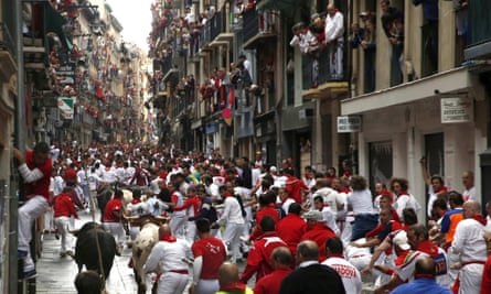 Bulls chase runners during the San Fermín festival