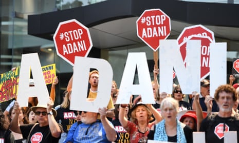 Anti Adani protesters hold signs outside the company’s offices in Brisbane, Australia, 13 September 2018.