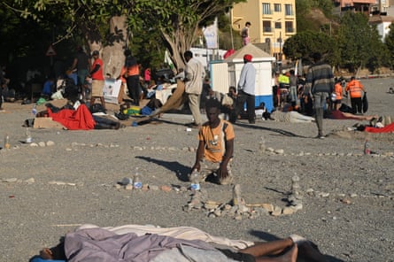 A man prays inside a makeshift mosque marked out with stones on El Trampolín beach in Ceuta, where hundreds of migrants have been sheltering.