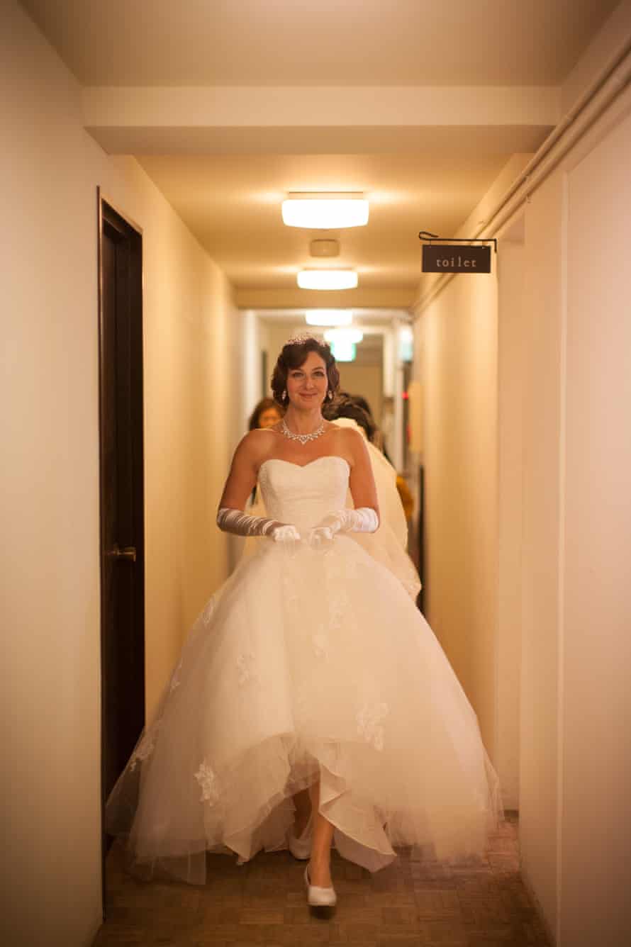 Naomi Harris leaving a hotel room in a wedding dress