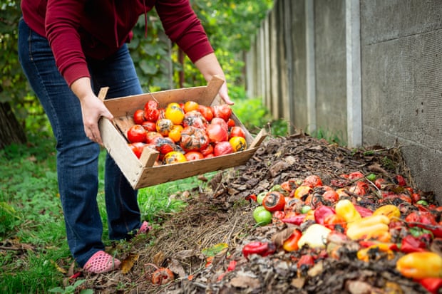 Woman adding to compost heap