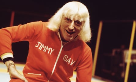 Jimmy Savile presenting Top Of The Pops in about 1973. He is wearing a personalised tracksuit.