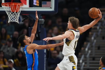 Johnny Furphy dunks over Oklahoma City Thunder’s Malevy Leons during an NBA preseason game.