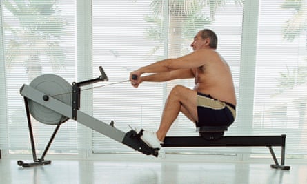 A large man on a rowing machine.