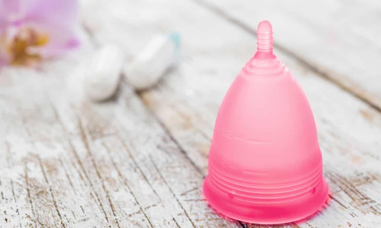 Menstrual cup and tampons on table