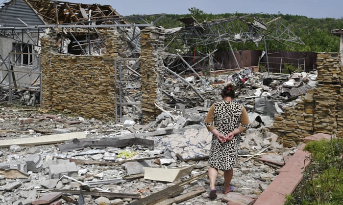 An elderly woman next to a building damaged by an overnight missile strike in Sloviansk, Ukraine.