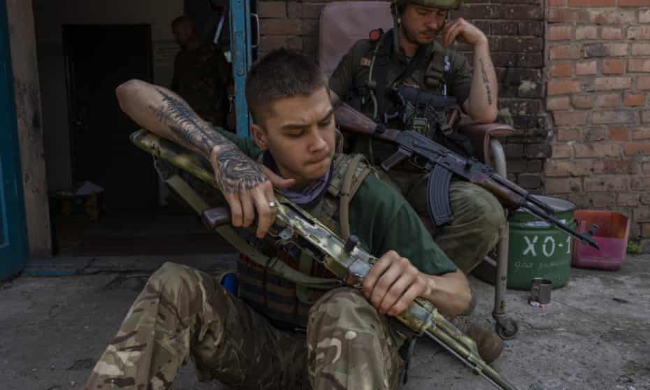 A security member of a medical rescue team cleans his weapon in the Donetsk oblast region on 4 June.