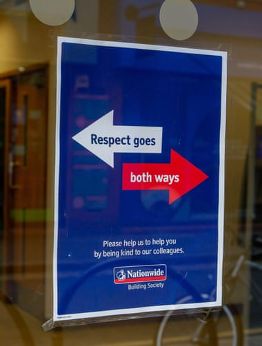 A ‘Respect goes both ways’ sign in a Nationwide building society window in Windsor.