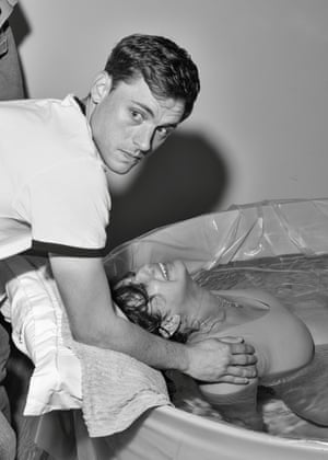 Woman in birthing pool with husband