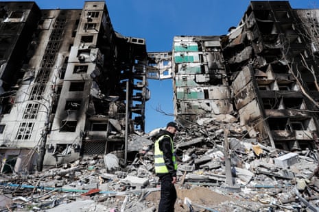 A man surveys the wreckage of the damaged residential buildings by the Russian air raids in Borodyanka.