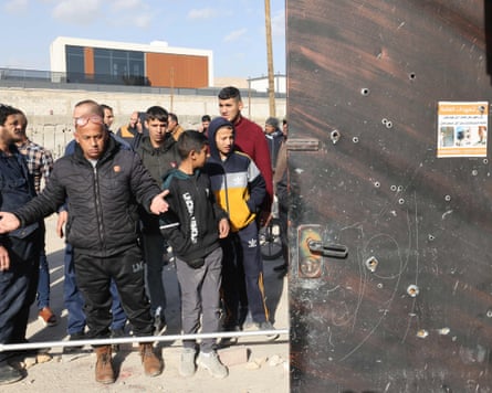 Onlookers gather in the aftermath of the raid in Aqabat Jabr by Israeli forces.