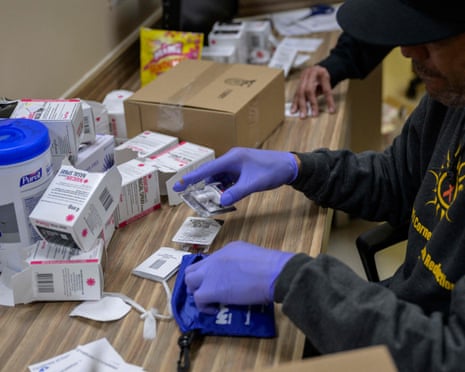 A staff member packs overdose prevention kits