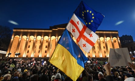EU, Georgia and Ukraine flags flying at a protest outside Georgia’s parliament in Tbilisi in March.