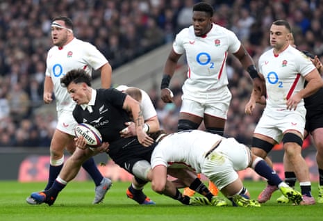 New Zealand's Leroy Carter is tackled by England's Joe Heyes and Guy Pepper.