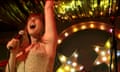 Jessie Buckley singing on stage in a scene from the film Wild Rose