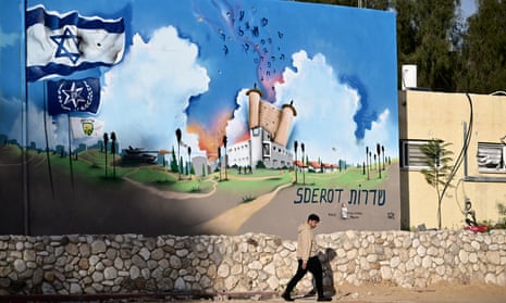 A man walks past the Sderot police station that was attacked by Hamas militants on 7 October.