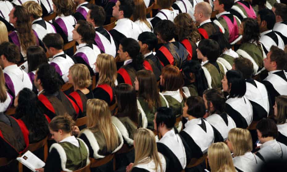 Students in gowns at a university graduation ceremony.