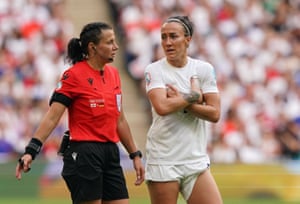 Lucy Bronze chats to referee Kateryna Monzul during a break in play.