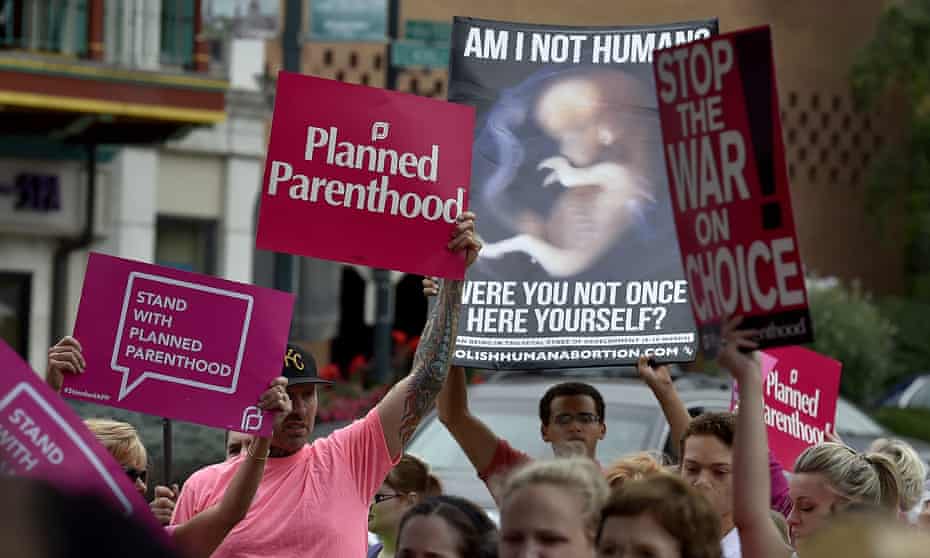 Planned Parenthood supporters clash with an anti-abortion demonstrator in Kansas City.