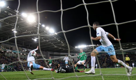 Northern Ireland’s Gavin Whyte scores their third goal.