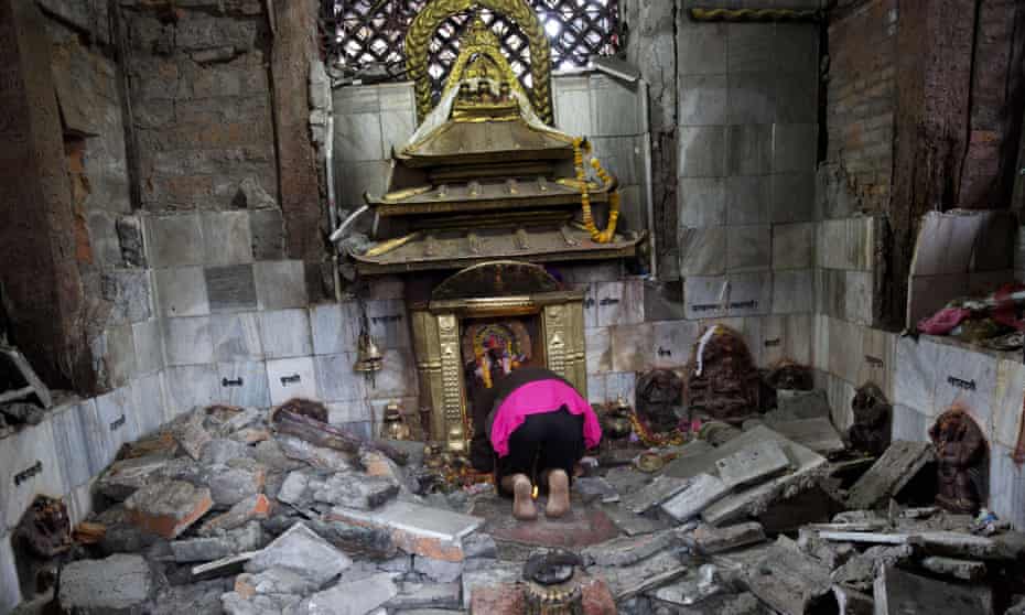 A Hindu Nepalese woman in Kathmandu, Nepal, offers prayers in the ruins of Indrayani temple