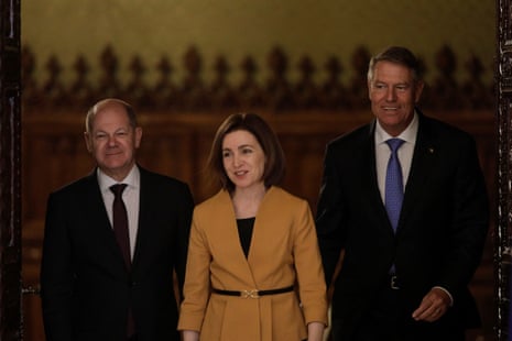 German Chancellor Olaf Scholz, Moldovan President Maia Sandu and Romanian President Klaus Iohannis arrive for a joint press conference in Bucharest, Romania.
