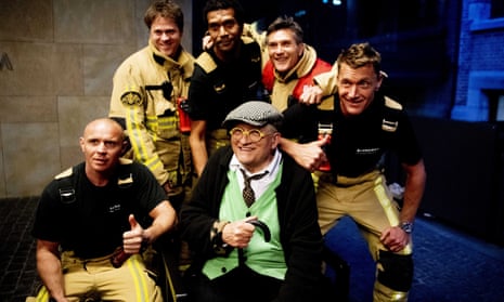 David Hockney poses with his rescuers after being stuck in the lift for 30 minutes. 