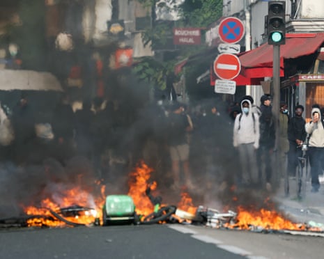 Students look at a fire as protesting students carry out blockading action at the Galilee vocation school, in Paris.