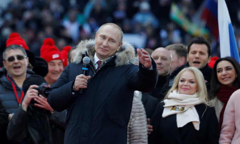 Vladimir Putin addresses a rally at the Luzhniki Stadium