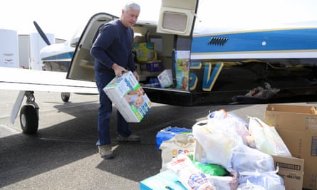 Pilot Herb Johansen of Bennington, Nebraska, unloads supplies he volunteered to fly into the Fremont airport, 18 March 2019.