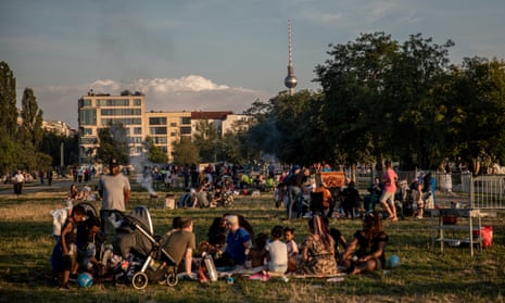 Visitors enjoy warm weather in Mauerpark in Berlin. Germany has seen a four-month high in new coronavirus cases.