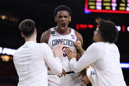 Tarris Reed of the UConn Huskies celebrates with teammates after Saturday’s win over Illinois.