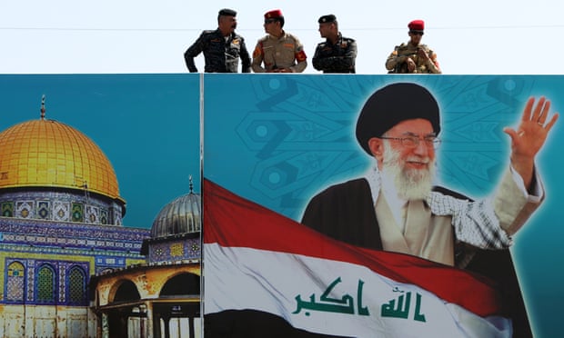Iraqi security forces on top of a building covered with a poster of Iran’s supreme leader Ayatollah Ali Khamenei, who last week ‘decided to set the record straight. This was in sum the pursuit of an arms control agreement, he said.’