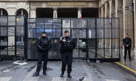 Police standing guard next to a barrier outside the constitutional council building on Friday.
