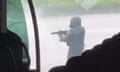 A gunman is seen after a prison van was attacked in Incarville in the Eure region of Normandy.