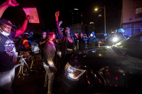 Protesters blocked a police car in downtown Los Angeles.
