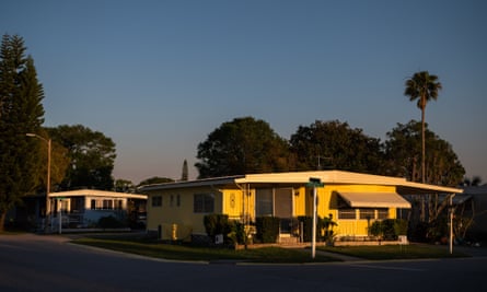 the sun sets over manufactured housing