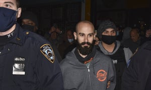 Danny Presti is taken away in handcuffs after being arrested on Tuesday.
