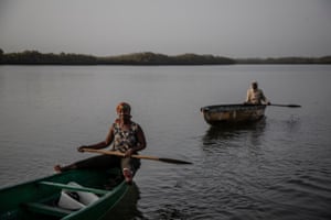Marie Sambou, and another Oyster Woman, in their canoes on the Gambia River.