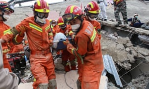 A man is rescued from the rubble of a collapsed hotel used as a coronavirus quarantine centre in Quanzhou, in China’s eastern Fujian province.